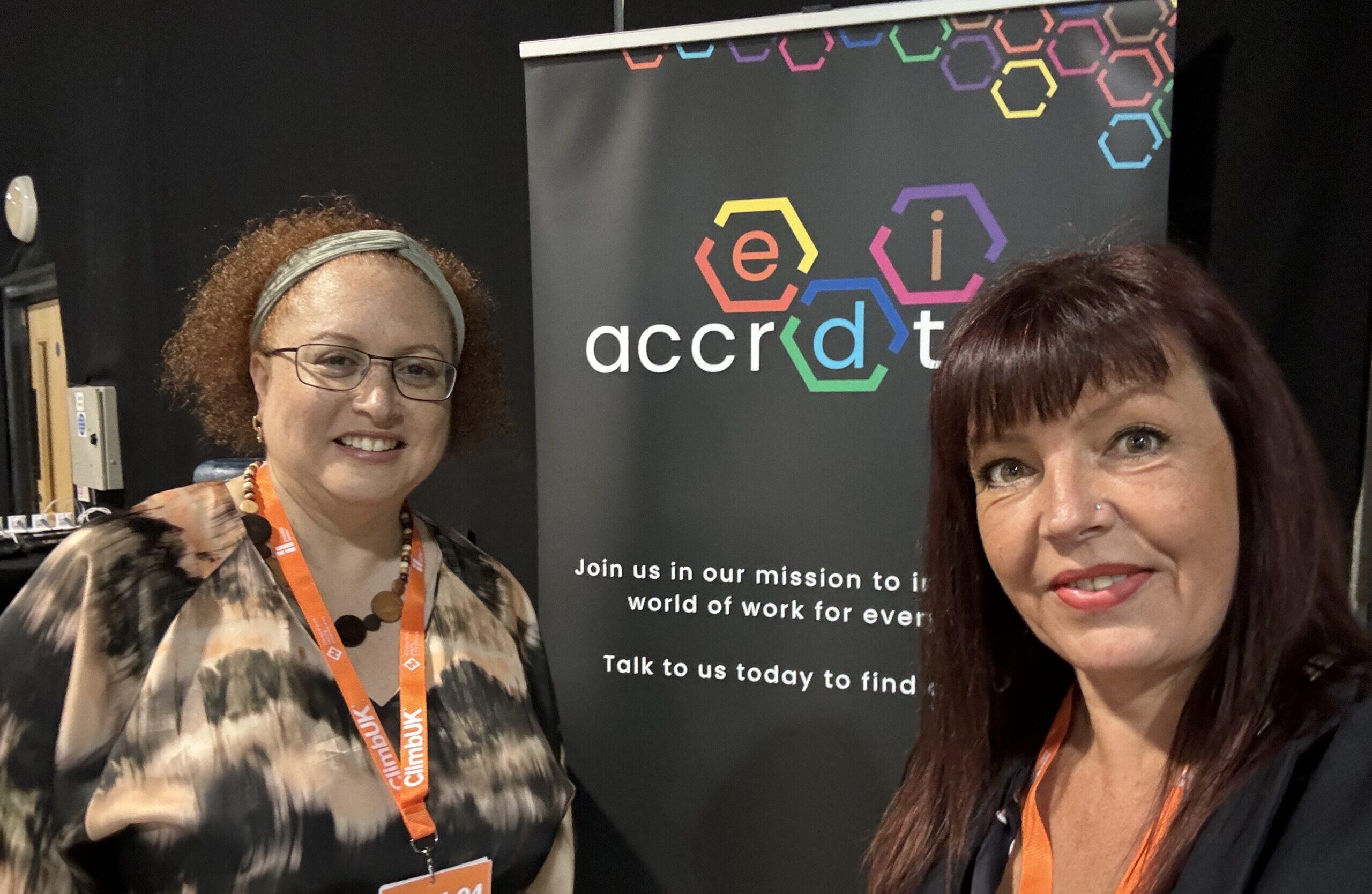 EDI Accreditation. Photo of two women in front of banner
