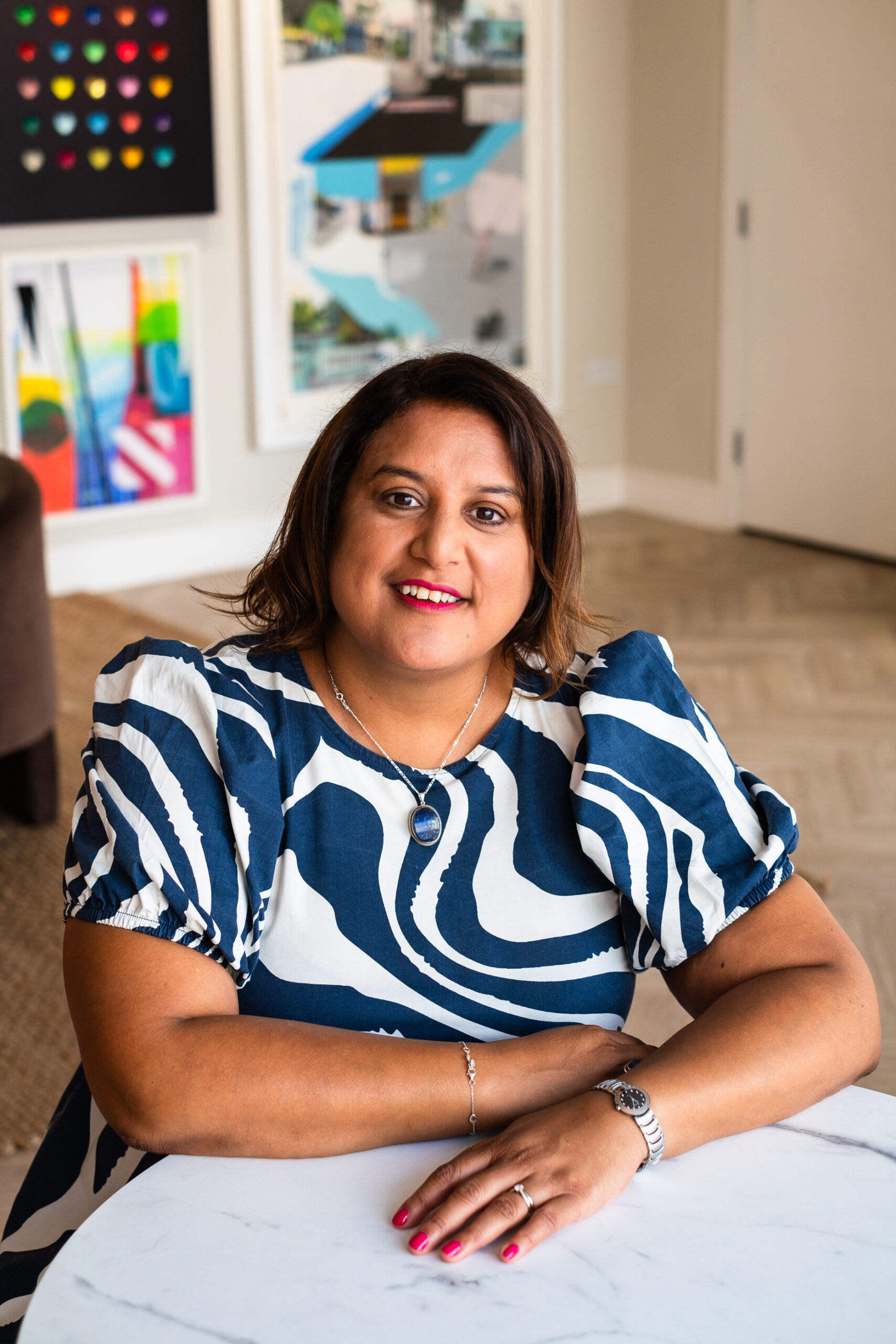 Mo smiling with patterned wall behind